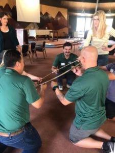 Picture of team-building exercise with hoop.